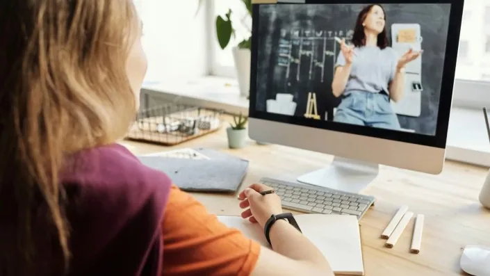 A woman sitting at her desk in front of a computer
