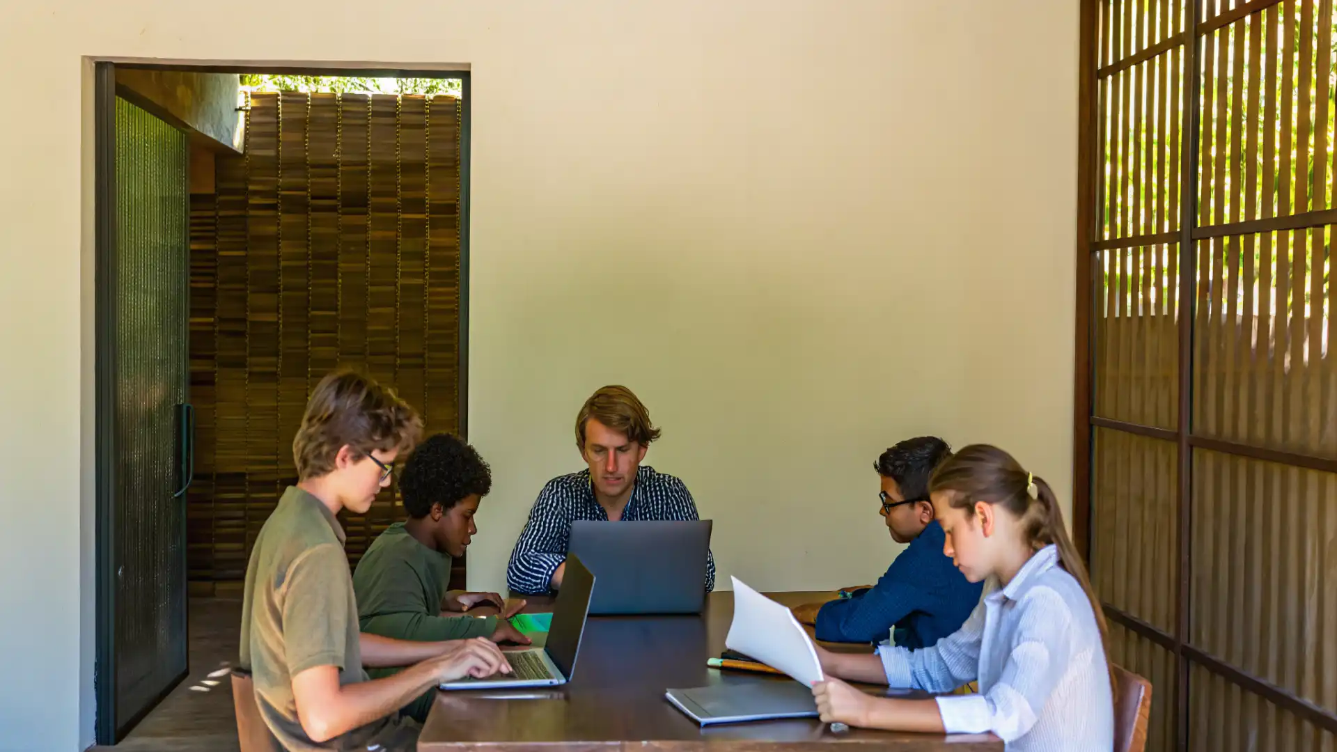 Group of students collaborating on academic enrichment activities in a modern study space
